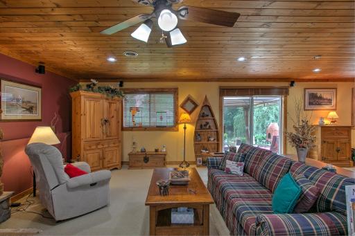 Lower level family room with tongue and groove paneling.