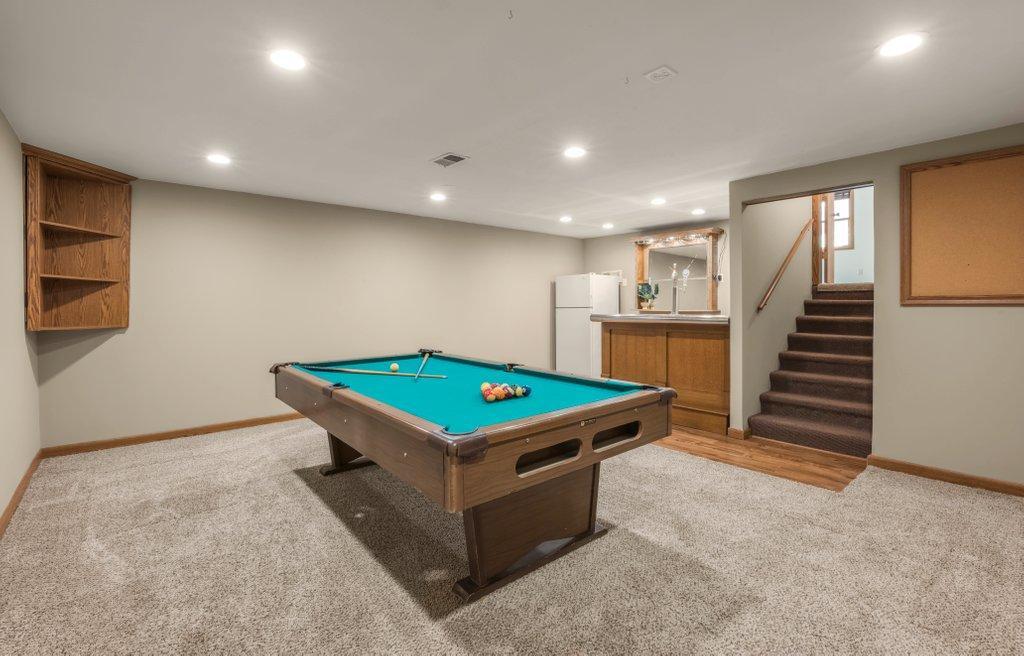Basement level includes Pool Table, Bar and Refrigerator. So many areas to entertain in this home.