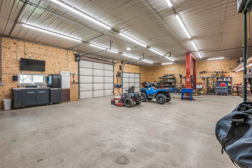 Dream Heated floor, Car Lift and 10' Garage Door. Pretty for the handy person. You can even host watch parties or larger parties in this space.