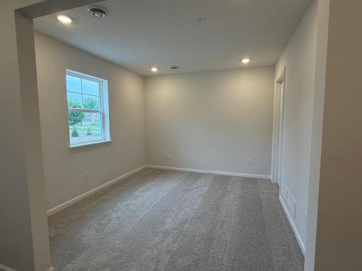 At the entry of the home, we have a spacious rec. space that is great, as a secondary living area, office, or even a makeshift 4th bedroom when you need added space!