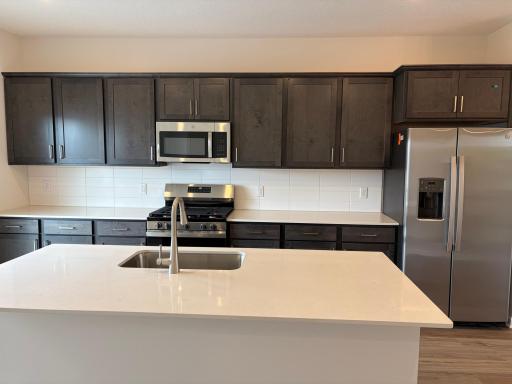 Welcome to the Barcelona! This homeâs kitchen features an oversized island and all the kitchen appliances. With plenty of seating for those on the go for the early mornings!