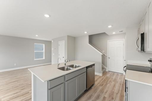Here you can see there is additional cabinet space on the island and a breakfast bar on the opposite side. Photo of spec home, colors and finishes vary.