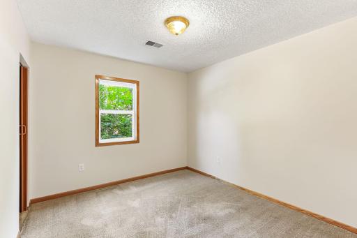 Light-filled secondary bedroom with new blinds, fresh paint, and ample space for guests or a home office