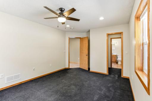 The primary bedroom offers a spacious layout and convenient access to the primary bathroom.