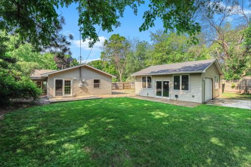 Beautiful rear exterior with a fully fenced backyard, fully insulated 2-car garage, multiple outdoor seating areas, and plenty of room to relax or entertain.