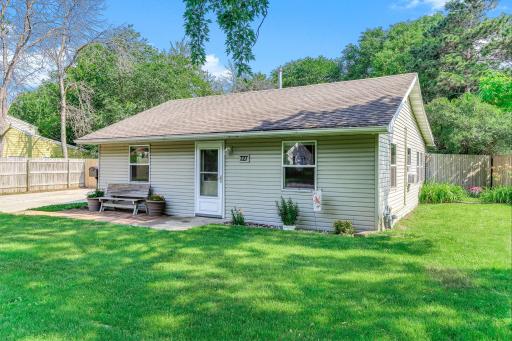 Beautiful front view featuring a well-maintained exterior, mature landscaping, and a generous front yard.