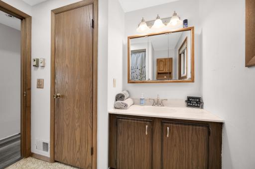Second full bath on the main level has great storage with the large linen closet in addition to the vanity and mirror storage.