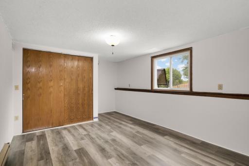 Lower level third bedroom has fresh paint, large closet and new LVP flooring.