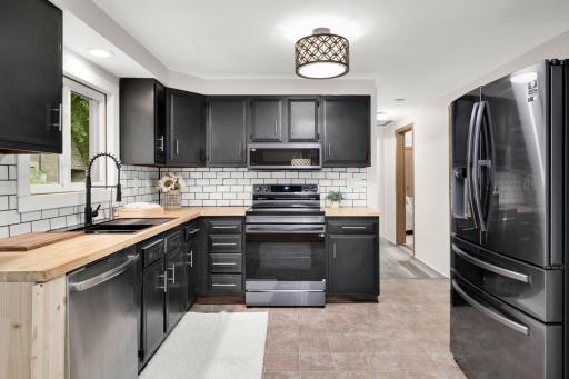 New black stainless appliances including a french door fridge, stove and upgraded slim microwave for more usable stove top space.