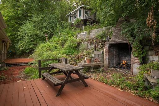 This tiered yard has so many options! Koi pond is in place and many gardening areas. Two decks and an outbuilding. What will you do with this space.