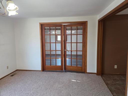 French doors to the primary have blinds in place for privacy