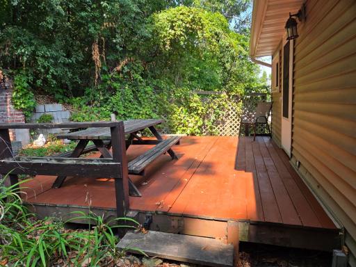 This deck is off of the family room addition and adjacent to the brick fireplace.