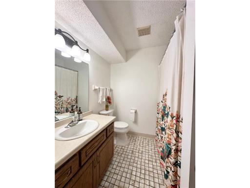 Full bathroom located on the upper level featuring quality tile finishes