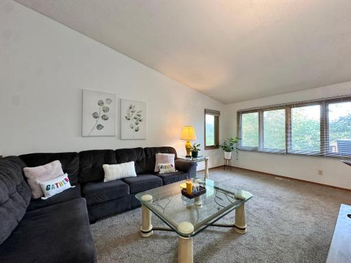 Notice the spacious living room with soaring ceilings, perfect for gathering with family and guests.