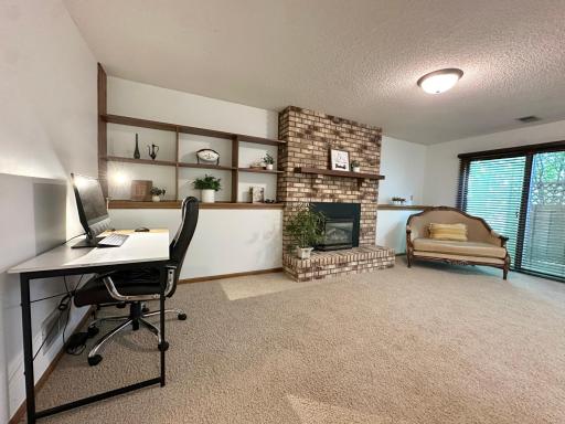 Spacious family room featuring a dedicated office space and a cozy gas fireplace