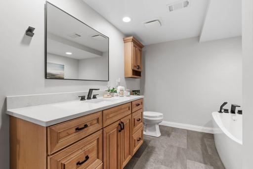 LL bath beautifully updated w/ free-standing tub & quartz counters