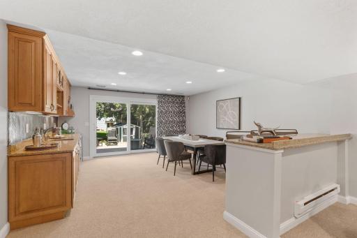 Walk-out Lower Level w/ Family Room, entertainment bar, gaming space + wet bar