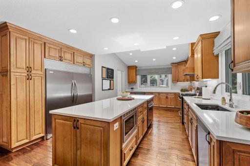 Fully remodeled Gourmet Kitchen w/ custom cabinetry, oversized island, quartz counters, SS apps + beverage fridge
