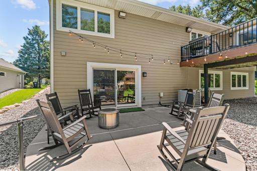 Walk out to concrete patio & stunning backyard featuring upgraded maintenance-free turf, boulder retaining wall, mature trees & storage shed (included)