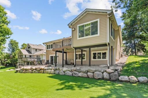 Incredible lot w/ mature trees, stunning landscaping + maintenance-free turf