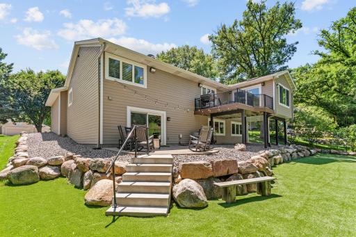 Incredible lot w/ mature trees, stunning landscaping + maintenance-free turf