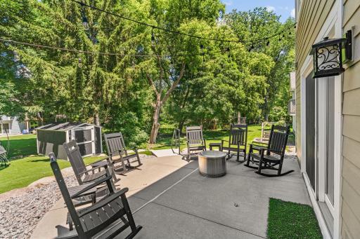 Walk out to concrete patio & stunning backyard featuring upgraded maintenance-free turf, boulder retaining wall, mature trees & storage shed (included)