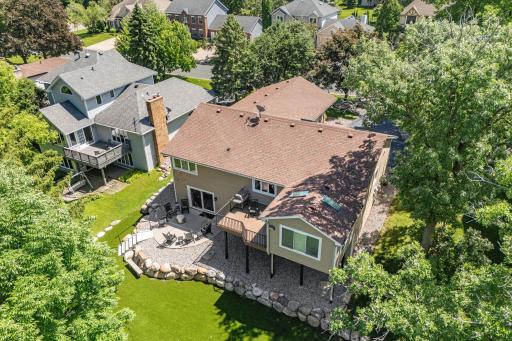 Incredible lot w/ mature trees, stunning landscaping + maintenance-free turf