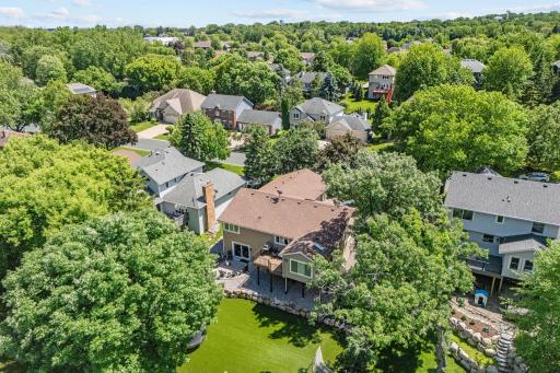 Incredible lot w/ mature trees, stunning landscaping + maintenance-free turf