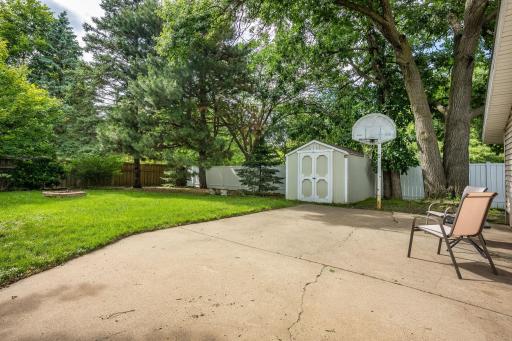Completely fenced in back yard with storage shed