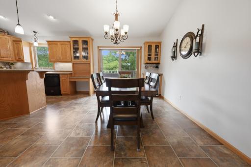 Dining room space with wine fridge and glass front cabinets.