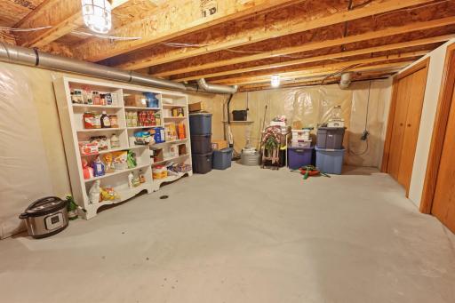 Basement storage room - lower ceilings, with so much room for storing all of the holiday totes!