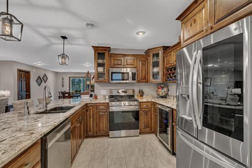 Hickory cabinets, tiled floors, granite tops, and excellent lighting merge to make a perfect kitchen lay out.
