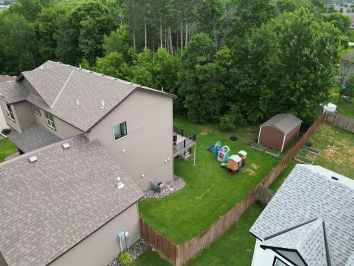 Fully fenced back yard with chain link and wood fence.