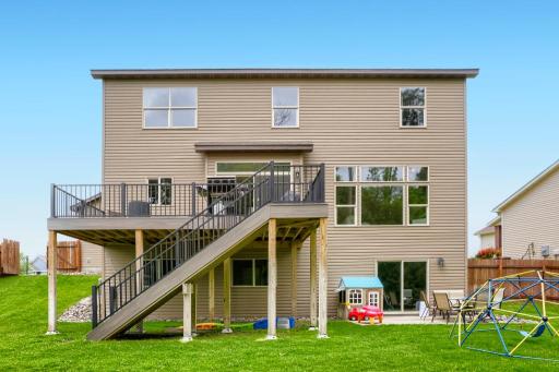 Back side of home. Southern Facing and afternoon sun! Maintenance free deck with stairs. Walkout basement. Garden shed and playset stays. Other kids play equipment is negotiable.
