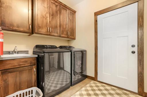 Main floor laundry and mud room with a 1/2 bath, laundry tub, and walk-in coat closet. Washer & Dryer are only a year old. Both electric and gas hookup for the dryer.