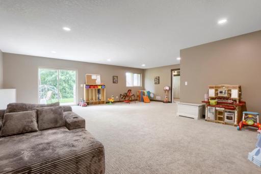 Walkout patio door to a large cement patio. Screen door is stored in the shed.