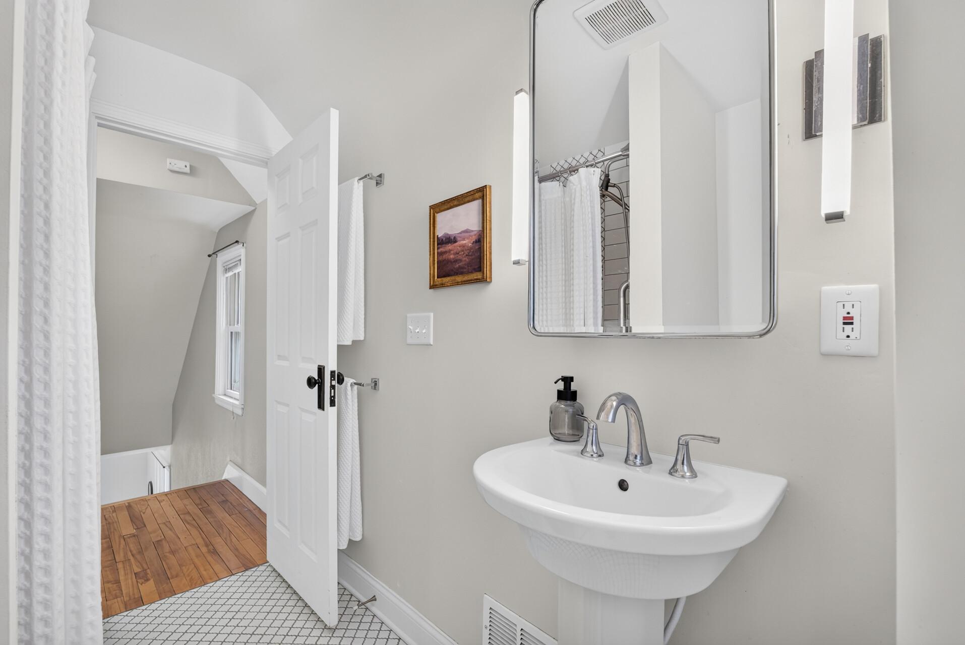 The bathroom is conveniently located at the top of the stairs