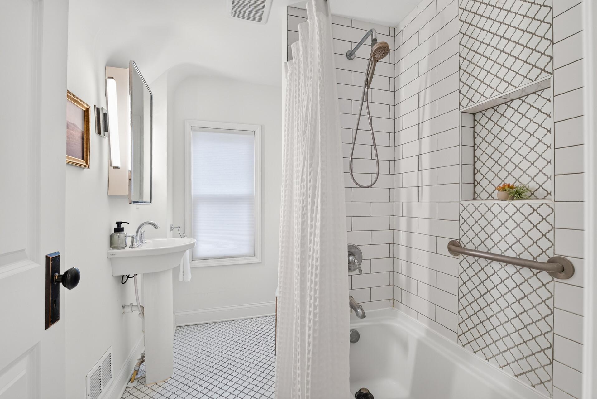 The upper level bathroom was sensitively renovated with tile one would expect of the vintage