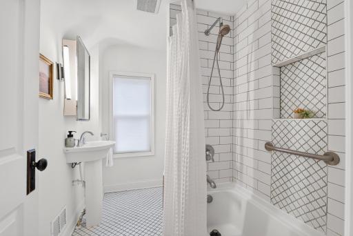 The upper level bathroom was sensitively renovated with tile one would expect of the vintage