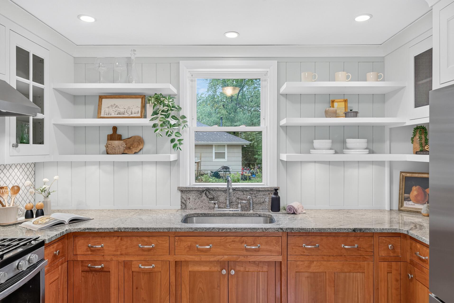 It has a window right over the kitchen sink, and a dishwasher hiding behind matching cabinetry between the sink and the refrigerator