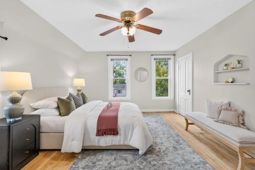 Ceiling fan in the primary bedroom... notice it also has a vintage 'niche'