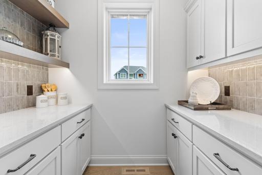 A thoughtfully designed walk-in pantry that offers exceptional storage and organization.
