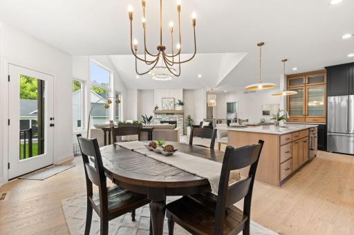 The adjacent dining area provides a bright and inviting space with direct walk-out access to the backyard patio—perfect for indoor-outdoor gatherings.