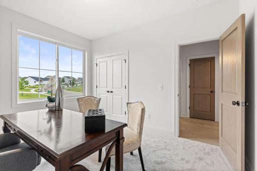 A versatile secondary bedroom on the main floor provide flexibility for guests, family, or a home office.