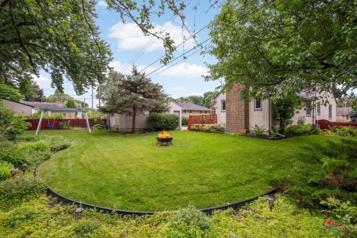 Large flat back yard with firepit area.