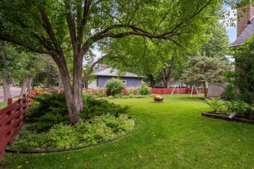 Terrific back yard with in-ground sprinkler and distinctive basket weave fence.