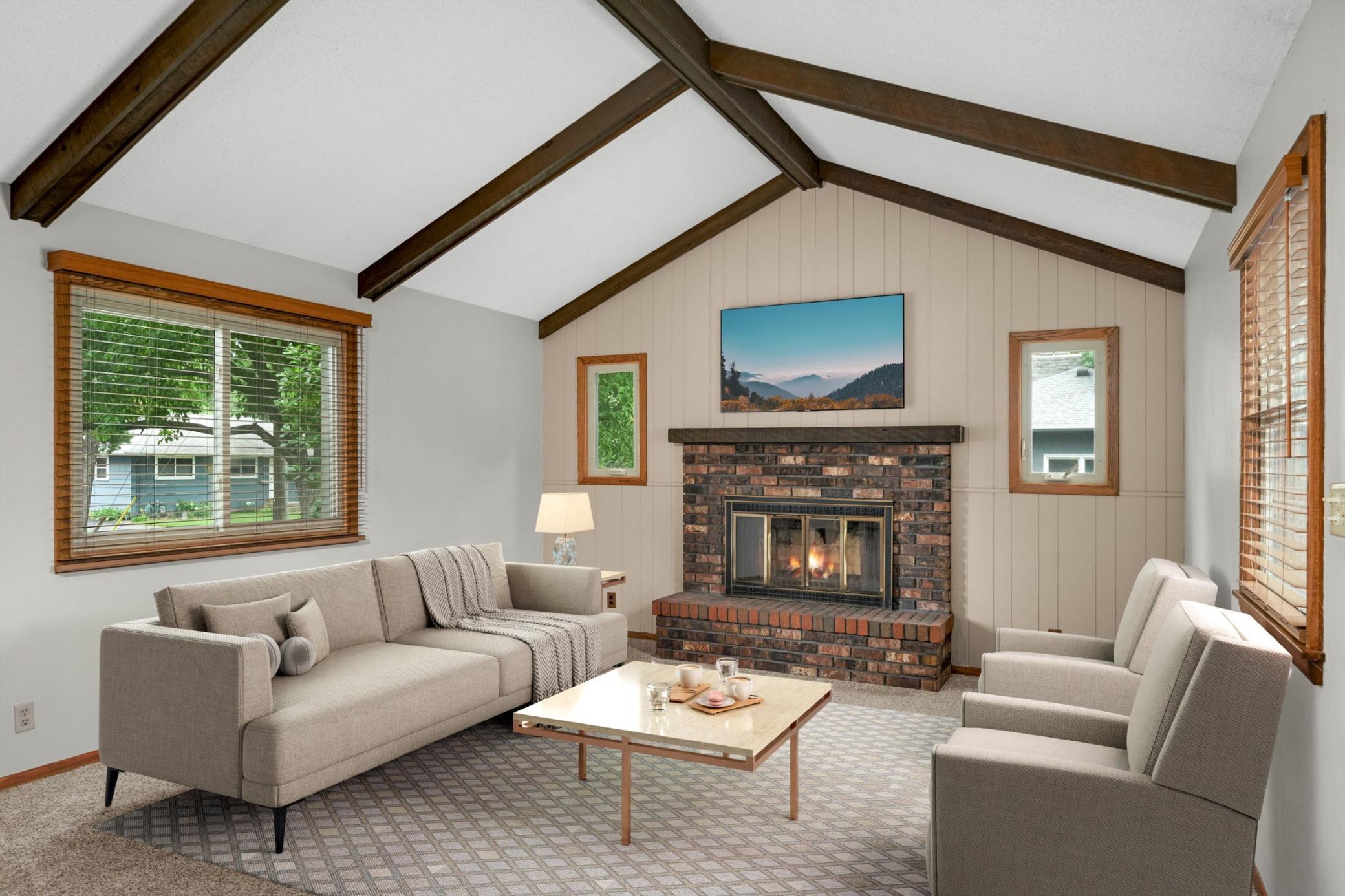 Family room with vaulted ceiling and wood burning fireplace.