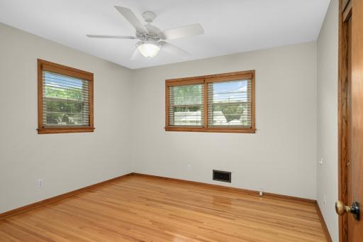 Main floor bedroom with hardwood floors.