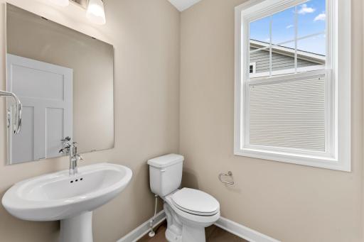 Conveniently placed near the Great Room, the powder room is conveniently trucked away with privacy in mind.