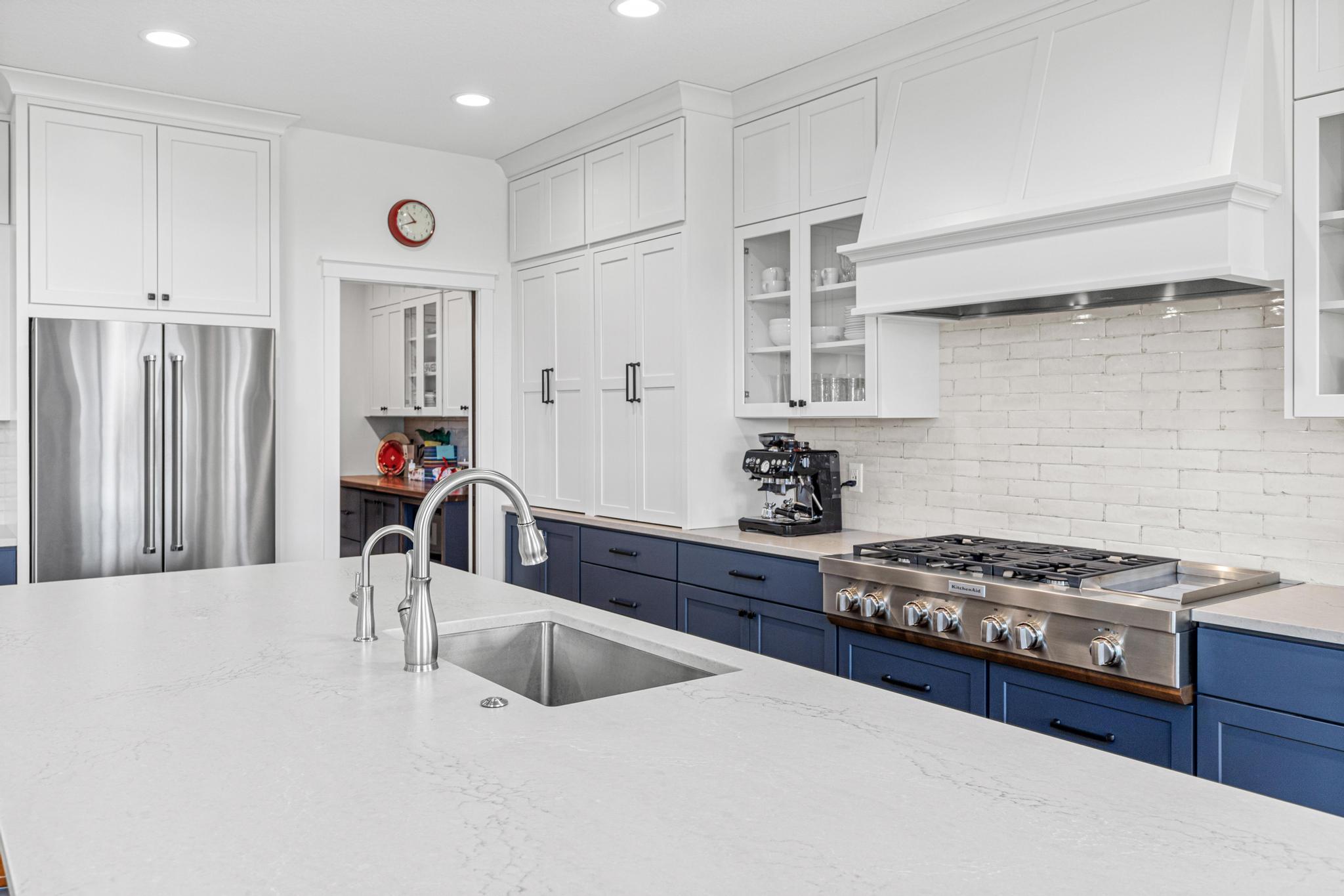 Beautiful custom cabinetry, high end appliances and solid surface countertops anchor this well-designed space. Entertain small and large groups in your beautiful home.
